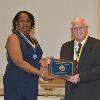 2022 Inductee Lloyd Austin is presented his plaque and medallion by DAHF Vice President LeSans Alexander.